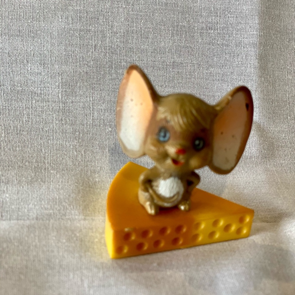 Vintage mouse sitting on Swiss cheese